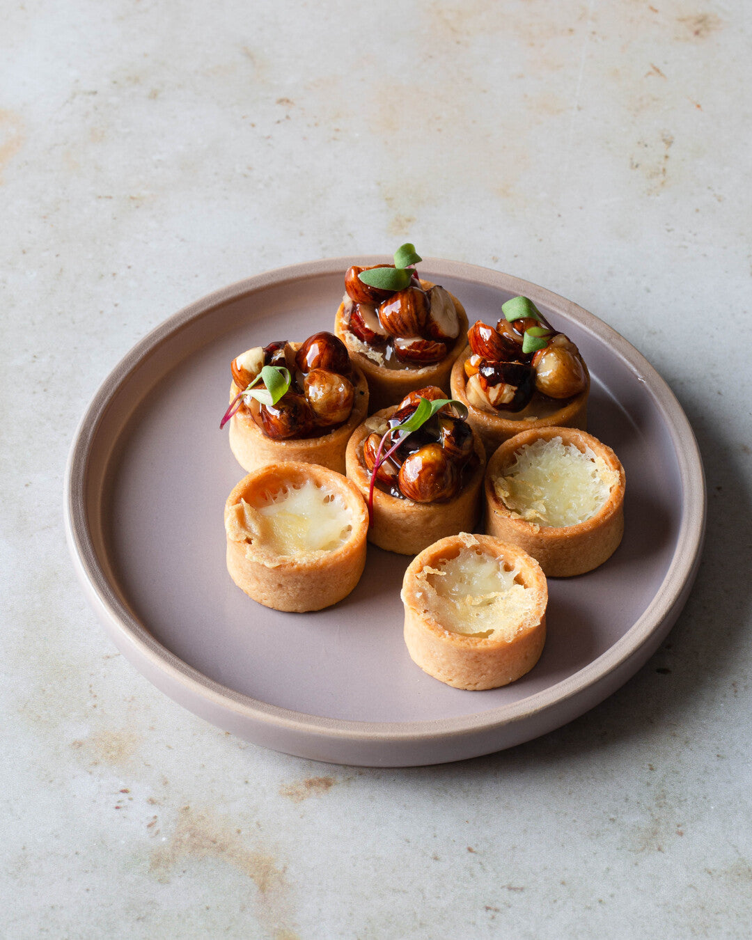 Manchegoa ja hasselpähkinähilloketta - cocktailpalat tarjoiluastialla.